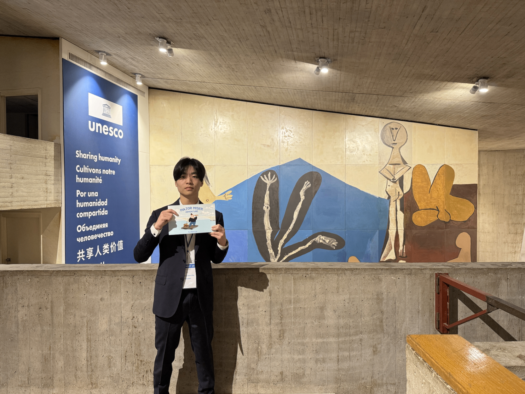 Major Money founder presenting the Major Miser Adventure book at UNESCO